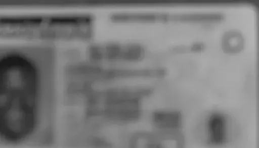 Example of a rejected ID photo: the same license blurred, dark, in black and white, with glare across the text